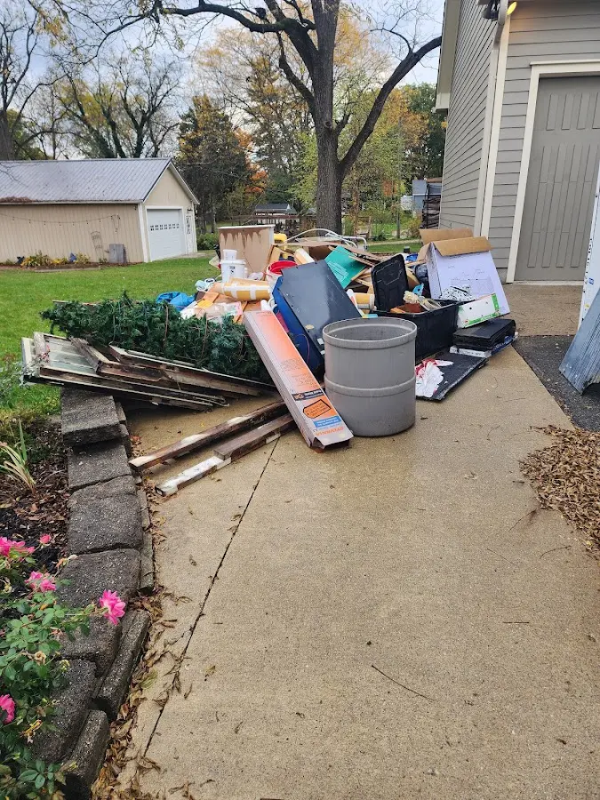 Dumpster being loaded with debris for 12 Yard Dumpster Rental in College Park